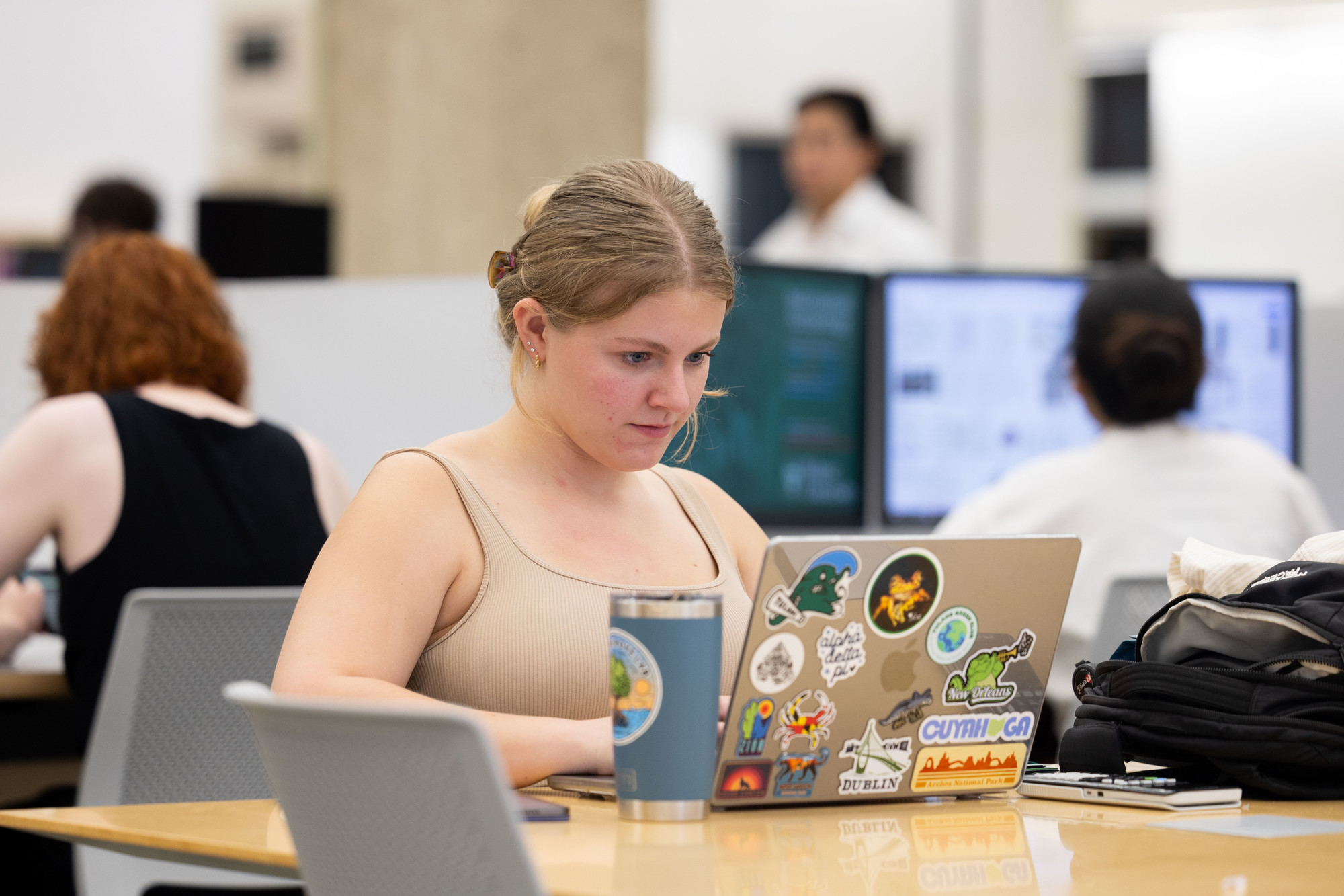 Student viewing laptop in the library